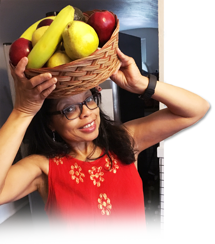 Addell Anderson holding a basket of fruit on her head