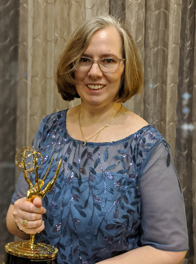 Katy Loebrich holding Emmy trophy