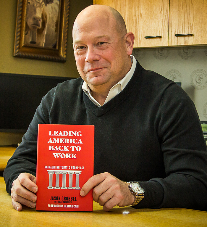 Jason Grobbel holding his book