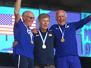 Herscher '66 and his team receiving gold medals