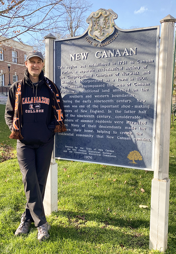 Robin Wells in front of New Canaan city sign