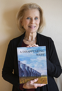 Helen Rietz holding her book, A Disappearing West