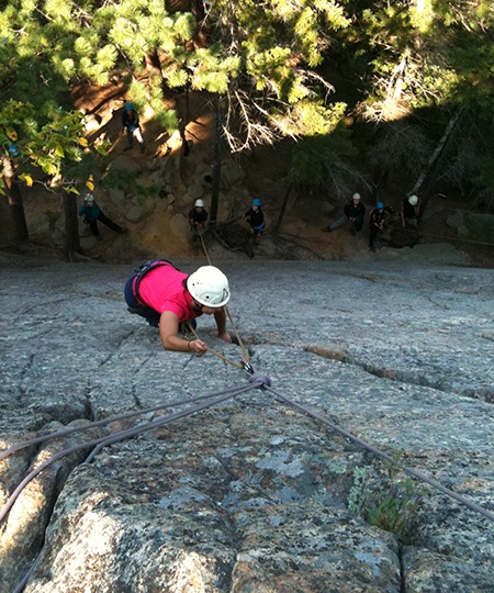 Student climbing up a cliff