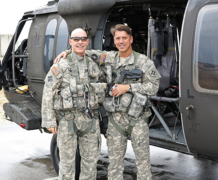 Meier with a pilot in front of a helicopter