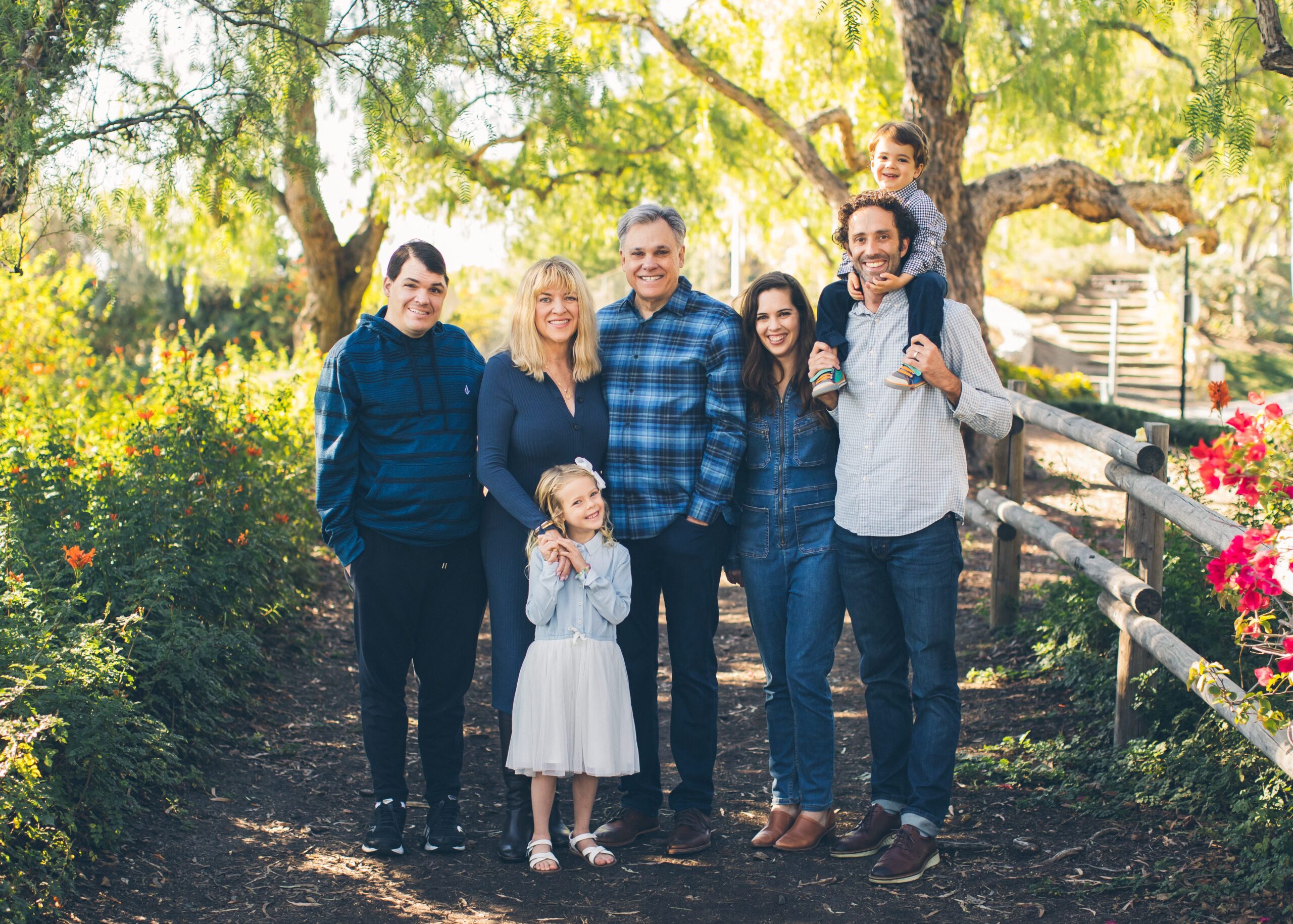 A happy family portrait of the Tempels, surrounded by greenery