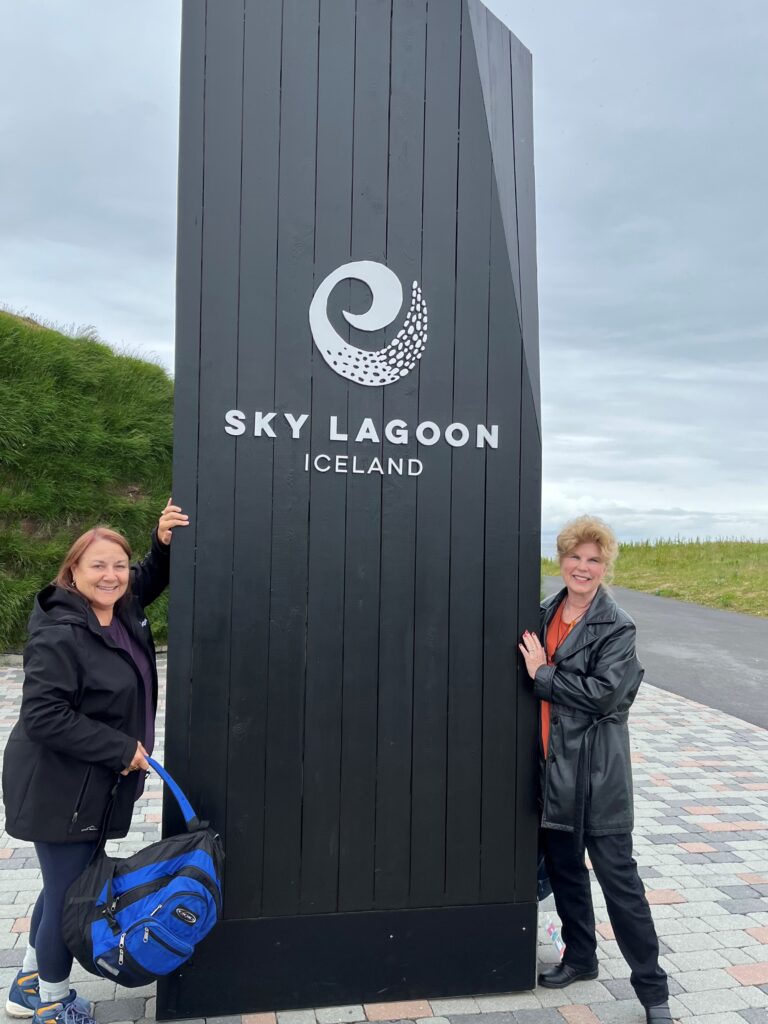 Bonnie Frenkel and Marty Stone smiling in front of the stunning Sky Lagoon Spa