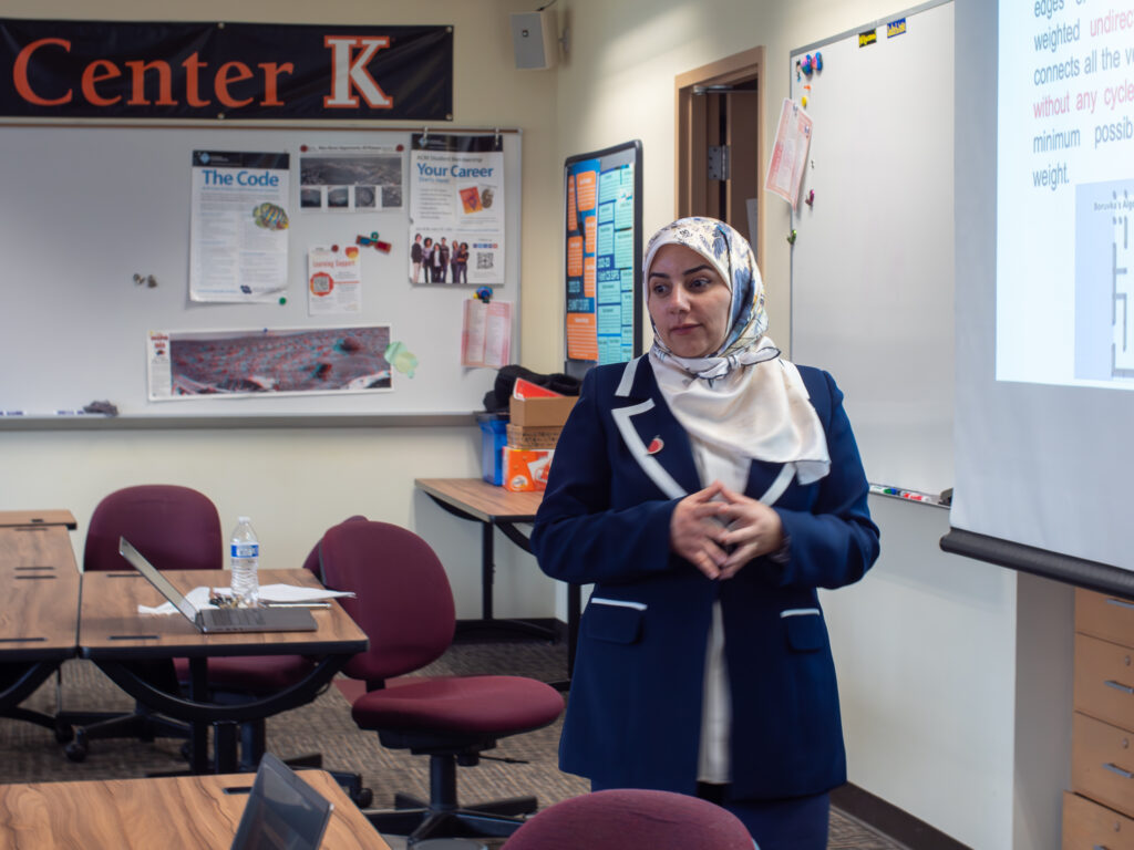 Professor Tasnim Gharaibeh leading a computer science lecture.