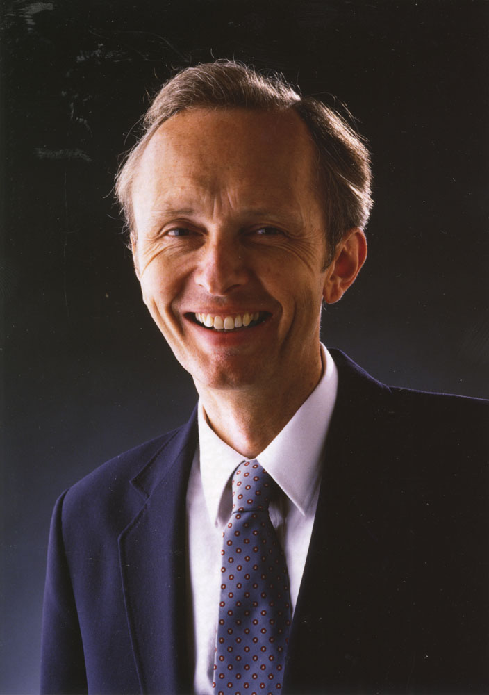 Timothy Light smiling in a suit and tie.